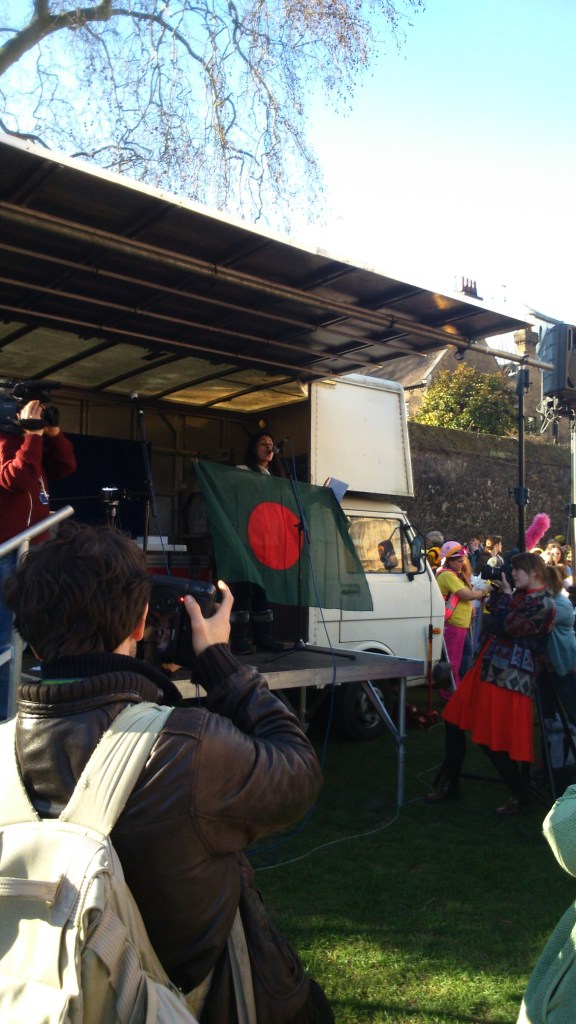 Rumana Hashem of Bangladesh National Committee and Phulbari Solidarity Group waves Bangladeshi flag to cheer up the protesters. Photo credit: Paul  V. Dudman 