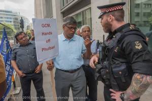 Arguments with Police - a community leader tells Police not to interfere with demonstrators. Photocredit: Peter Marshall