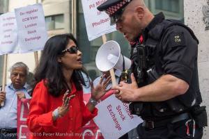 Arguments with Police who prohibited Rumana Hashem to display the banner for the victims on the pavement Copyright Peter Marshall